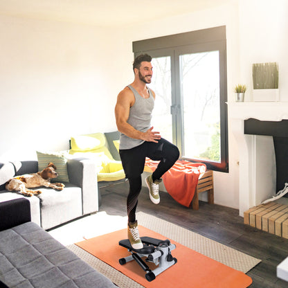 Man stepping on the hydraulic step machine in a living room