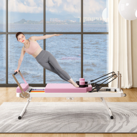 Woman doing a side plank on the folding Pilates reformer