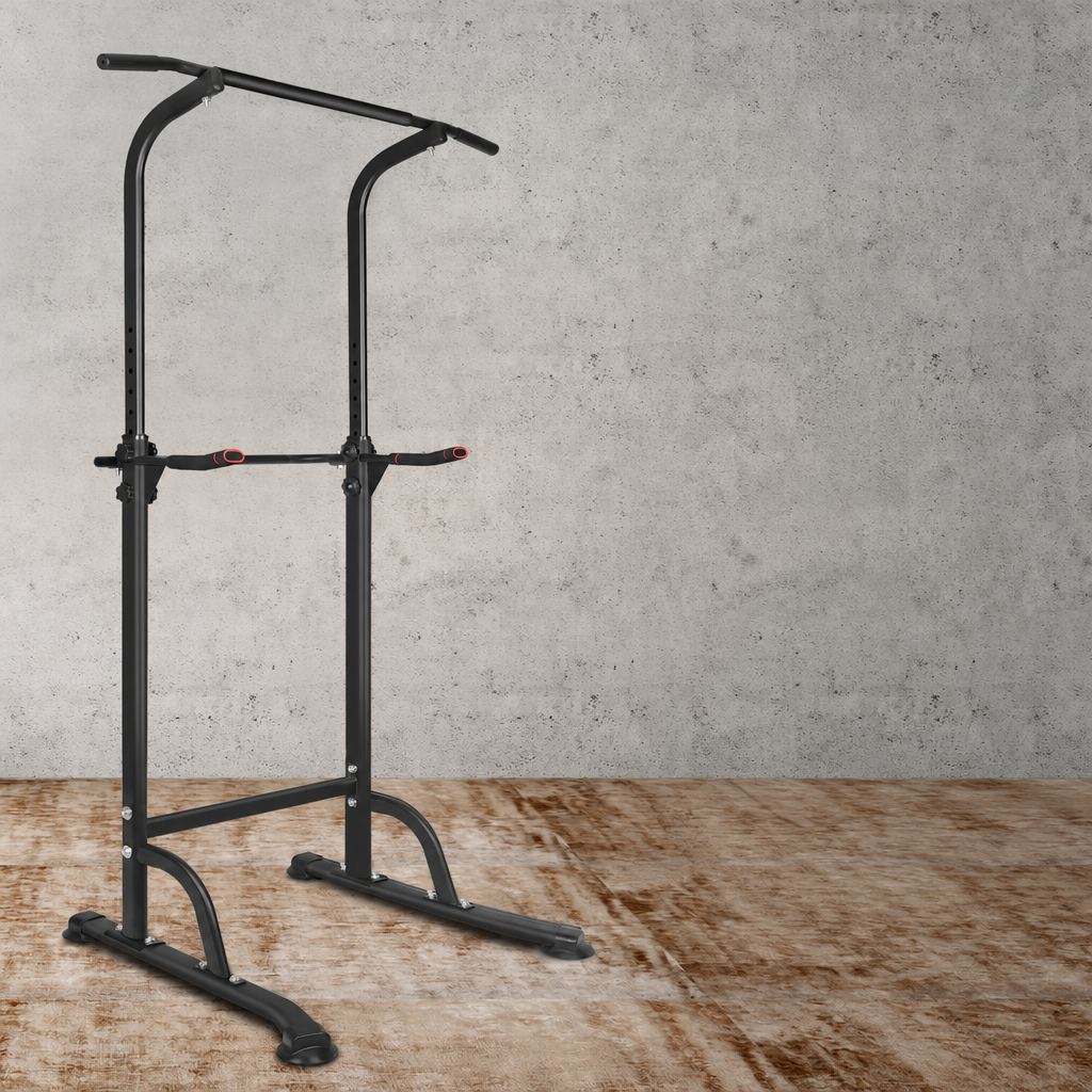 Power tower pull-up and dip station standing in a room